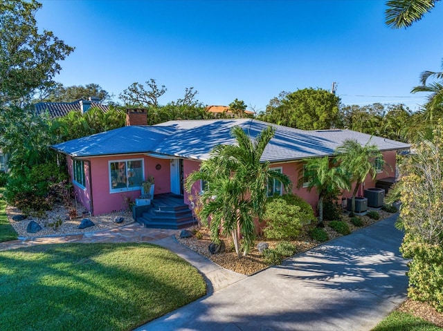 view of front of house featuring a front yard and central AC