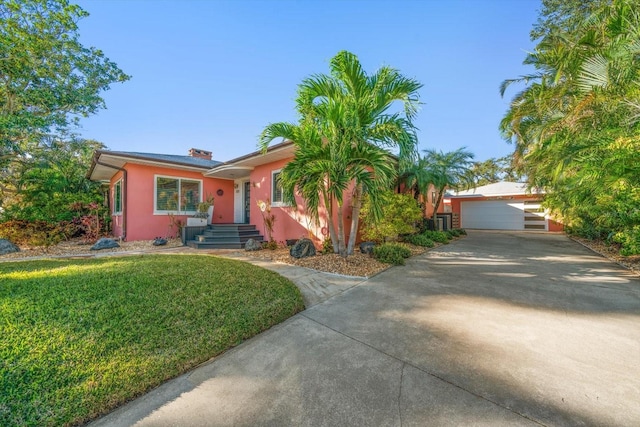 ranch-style house with a garage and a front yard