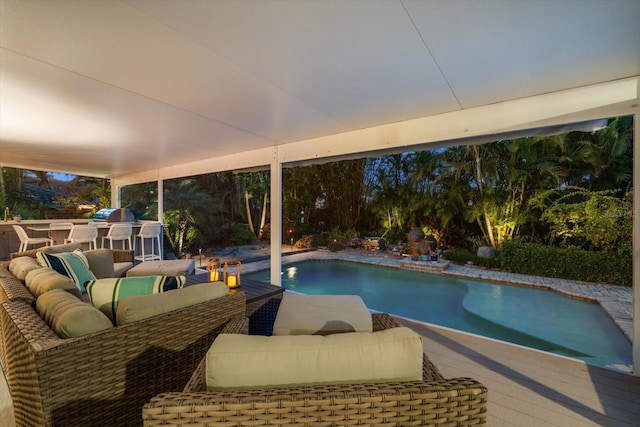 view of pool with outdoor lounge area and a deck