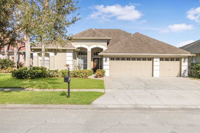 view of front facade featuring a front yard and a garage