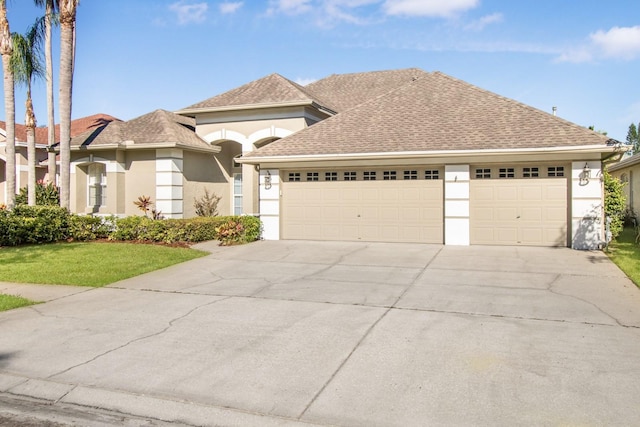 view of front of house featuring a garage and a front yard