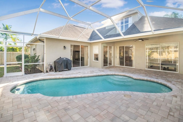 view of swimming pool with a lanai, a patio area, ceiling fan, and grilling area