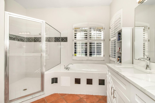 bathroom with tile patterned floors, vanity, and plus walk in shower