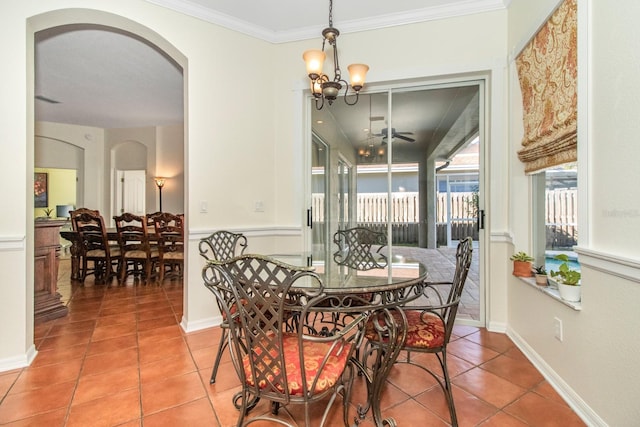 tiled dining room with ceiling fan with notable chandelier and crown molding