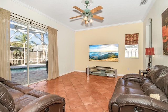 living room featuring tile patterned floors, ceiling fan, and ornamental molding