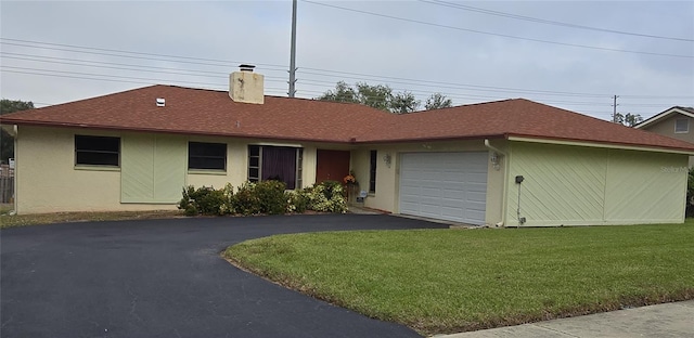 view of front facade featuring a front yard and a garage