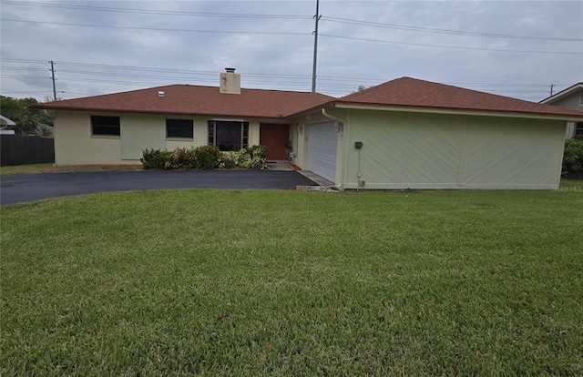 view of front of property featuring a front lawn and a garage