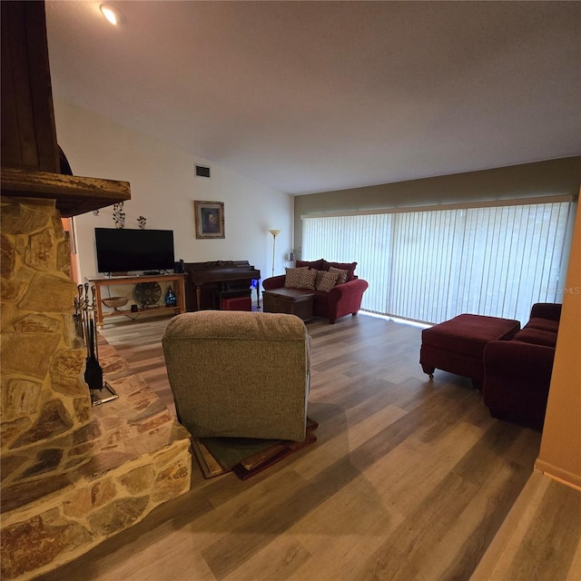 living room featuring hardwood / wood-style flooring and vaulted ceiling