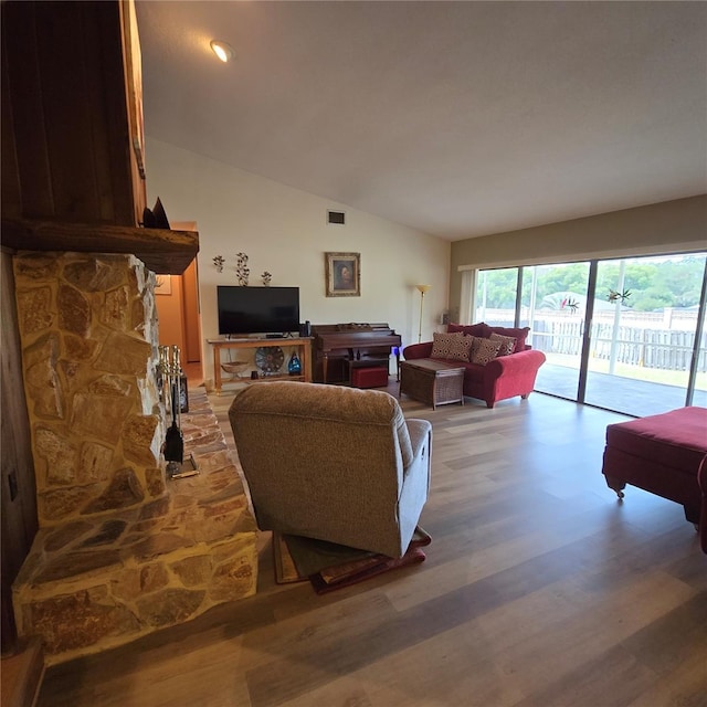 living room with vaulted ceiling and wood-type flooring