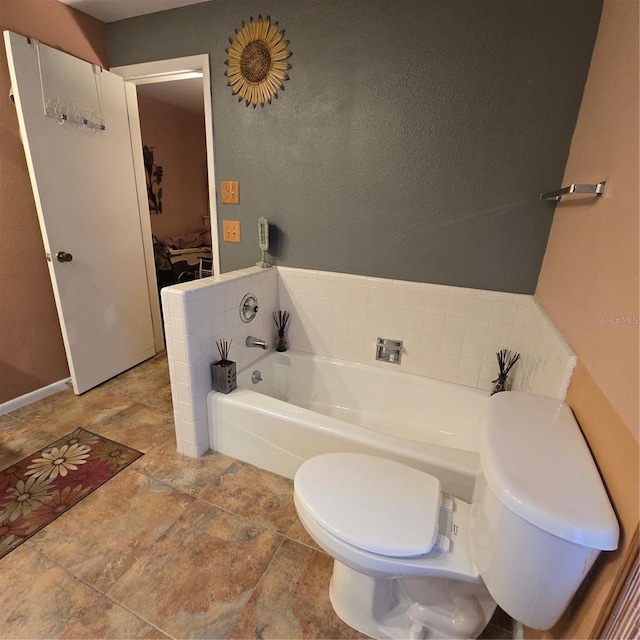 bathroom with toilet and a tub