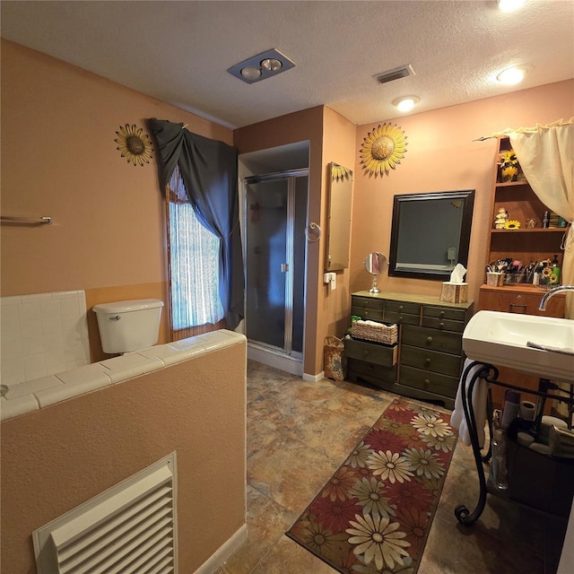 bathroom with toilet, a textured ceiling, and vanity