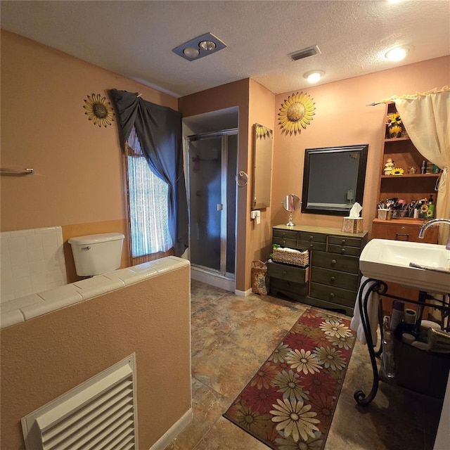 bathroom featuring toilet and a textured ceiling