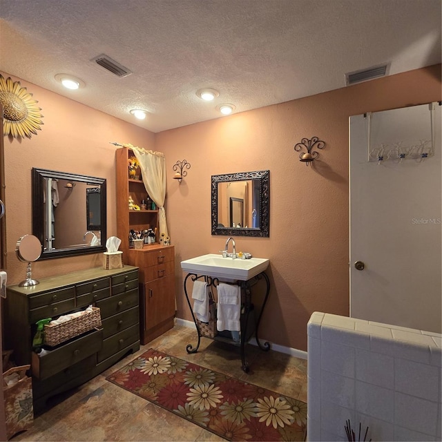 bathroom with a textured ceiling