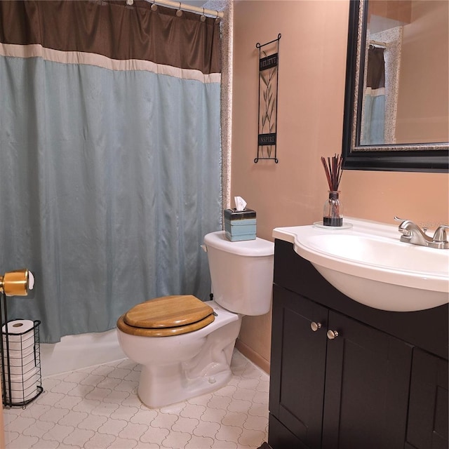 bathroom featuring toilet, tile patterned floors, and vanity