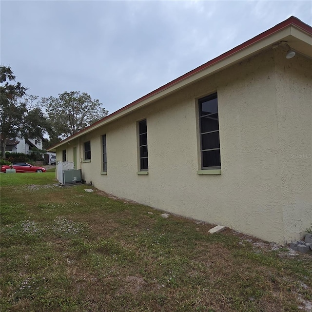 view of side of home with a yard