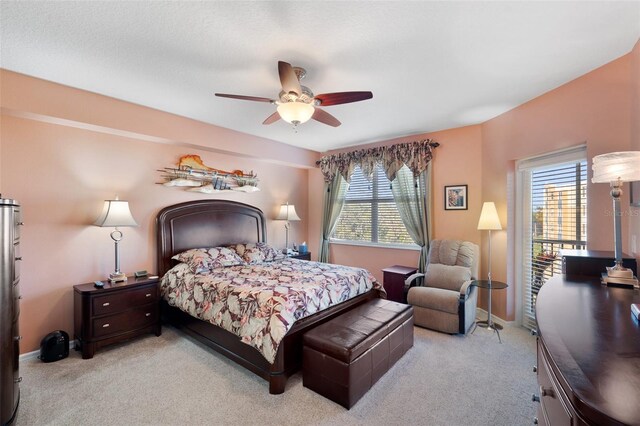 carpeted bedroom featuring multiple windows and ceiling fan