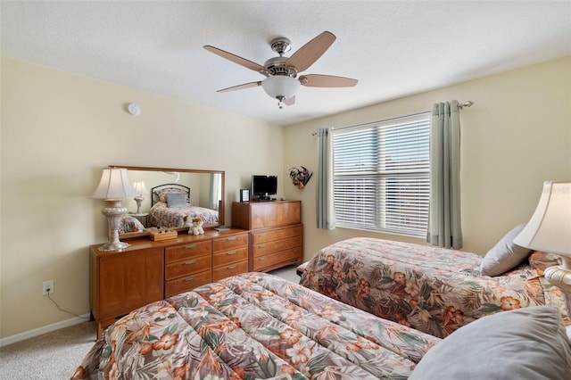 carpeted bedroom featuring a textured ceiling and ceiling fan