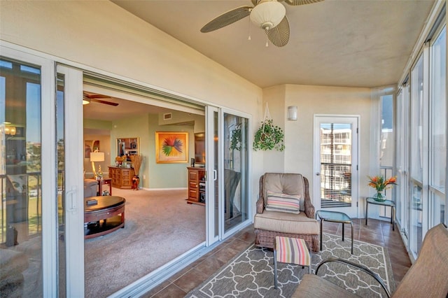 sunroom featuring ceiling fan