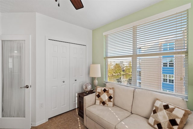 living room with tile patterned floors and ceiling fan