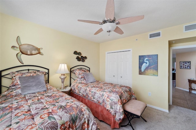 carpeted bedroom with ceiling fan and a closet