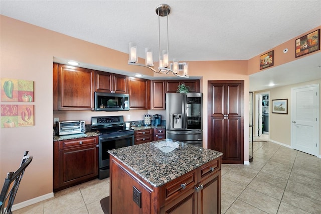 kitchen with appliances with stainless steel finishes, dark stone counters, a textured ceiling, pendant lighting, and a center island