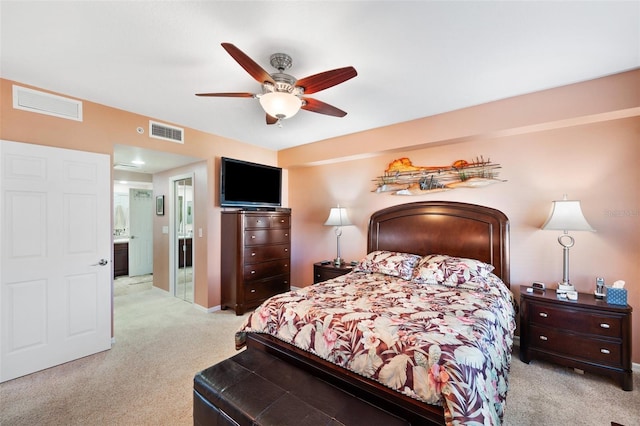 carpeted bedroom with ceiling fan and connected bathroom