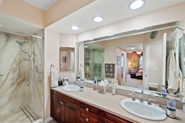 bathroom featuring vanity, ceiling fan, and a tile shower