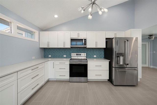 kitchen with appliances with stainless steel finishes, backsplash, a textured ceiling, and white cabinetry