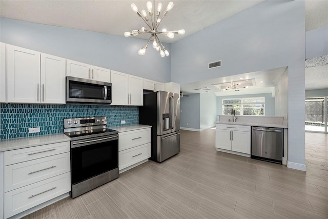 kitchen featuring white cabinets, a textured ceiling, and stainless steel appliances