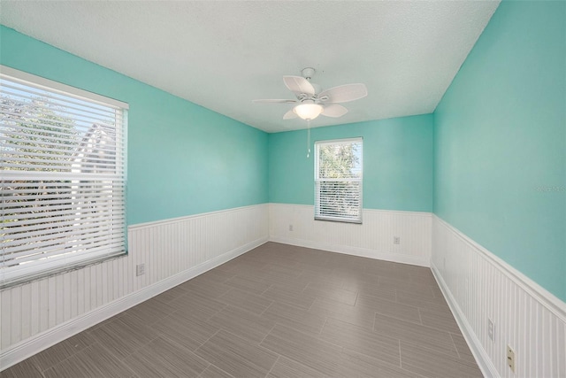 spare room with ceiling fan and a textured ceiling