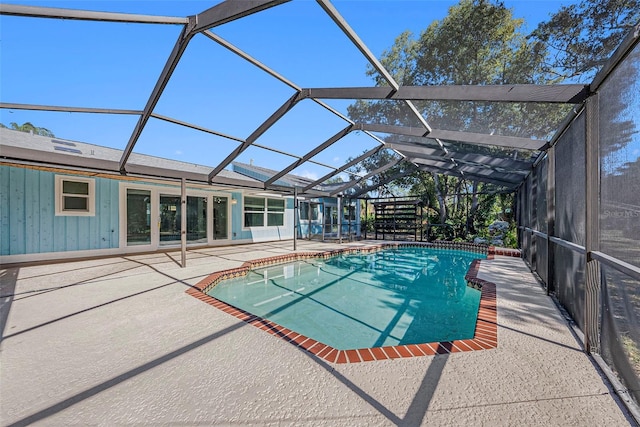 view of swimming pool with a patio and a lanai