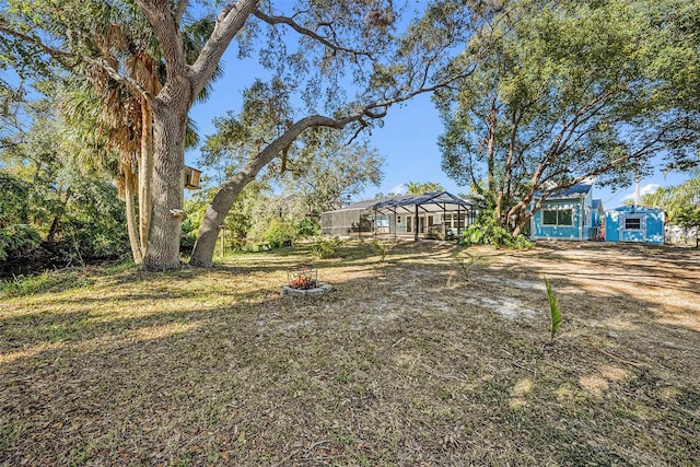 view of yard with a lanai