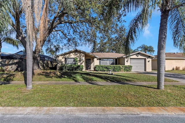 single story home with a garage and a front lawn