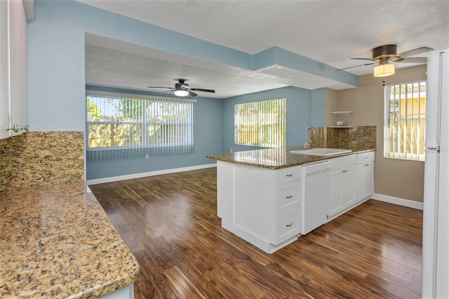 kitchen featuring white appliances, dark wood-type flooring, white cabinets, sink, and a healthy amount of sunlight