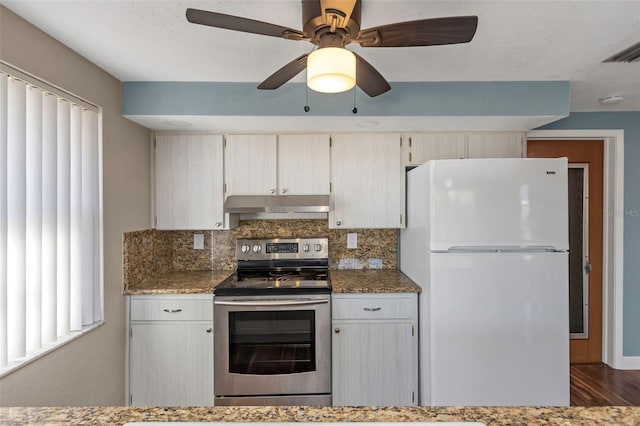 kitchen featuring stainless steel electric range, white refrigerator, decorative backsplash, dark hardwood / wood-style floors, and dark stone countertops