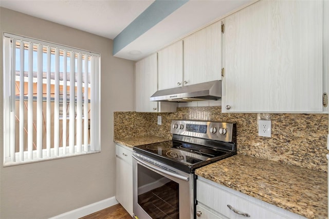 kitchen with decorative backsplash, hardwood / wood-style floors, electric range, and light stone counters