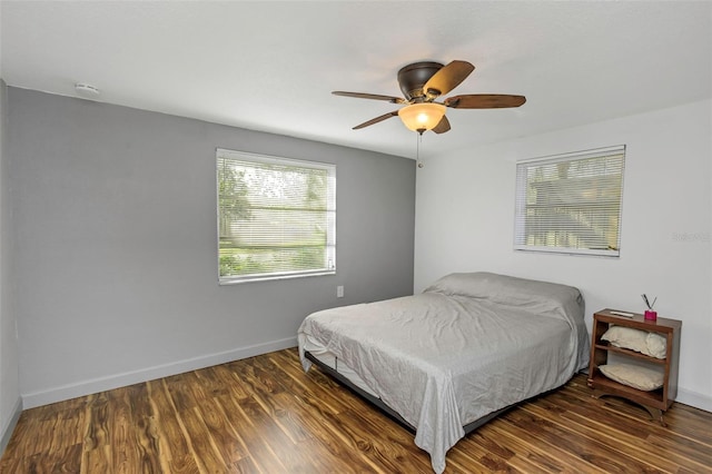 bedroom with dark hardwood / wood-style floors and ceiling fan