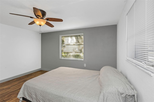 bedroom featuring dark hardwood / wood-style floors and ceiling fan