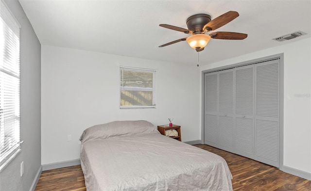 bedroom featuring ceiling fan, a closet, and dark hardwood / wood-style floors