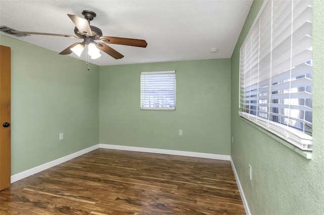 empty room featuring ceiling fan and dark hardwood / wood-style flooring