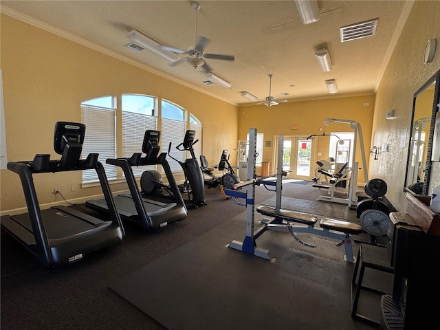 exercise room featuring a textured ceiling, ceiling fan, and crown molding