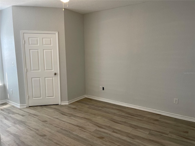 empty room with hardwood / wood-style floors