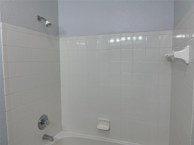 bathroom with bathing tub / shower combination