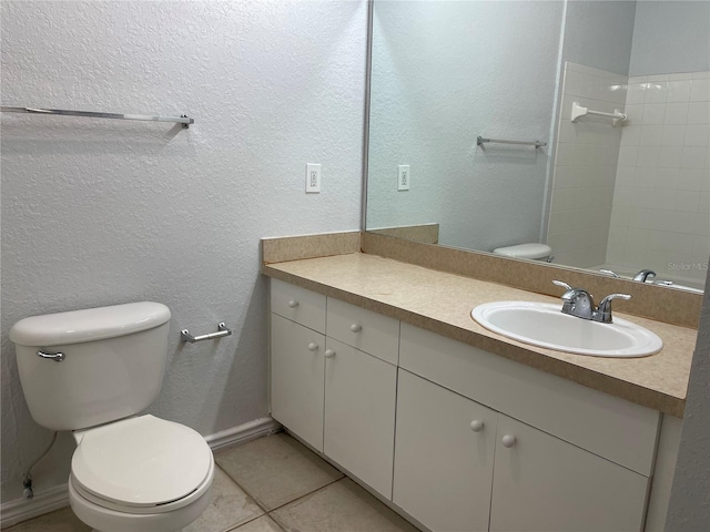 bathroom featuring tile patterned flooring, vanity, and toilet