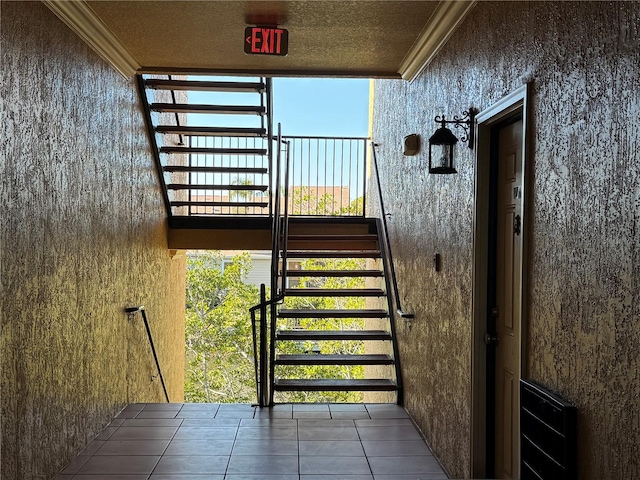 staircase with tile patterned flooring and crown molding