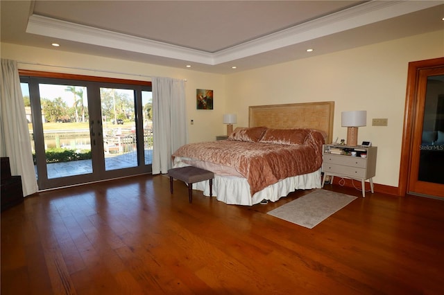 bedroom with french doors, dark hardwood / wood-style flooring, access to outside, a raised ceiling, and crown molding