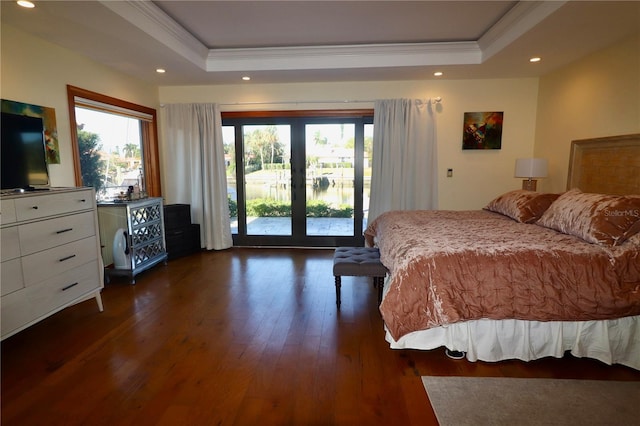 bedroom with a raised ceiling, access to exterior, crown molding, and dark wood-type flooring