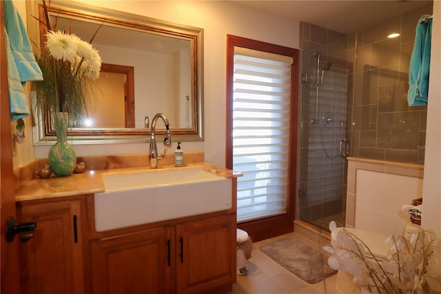 bathroom with tile patterned flooring, vanity, an enclosed shower, and toilet