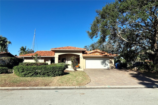 mediterranean / spanish-style home featuring a garage