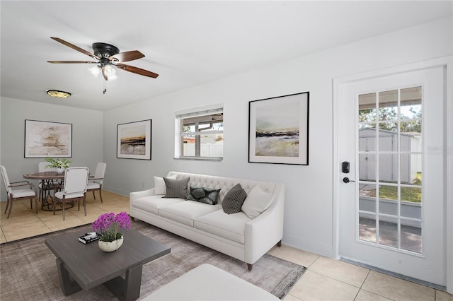 living room with light tile patterned floors, plenty of natural light, and ceiling fan